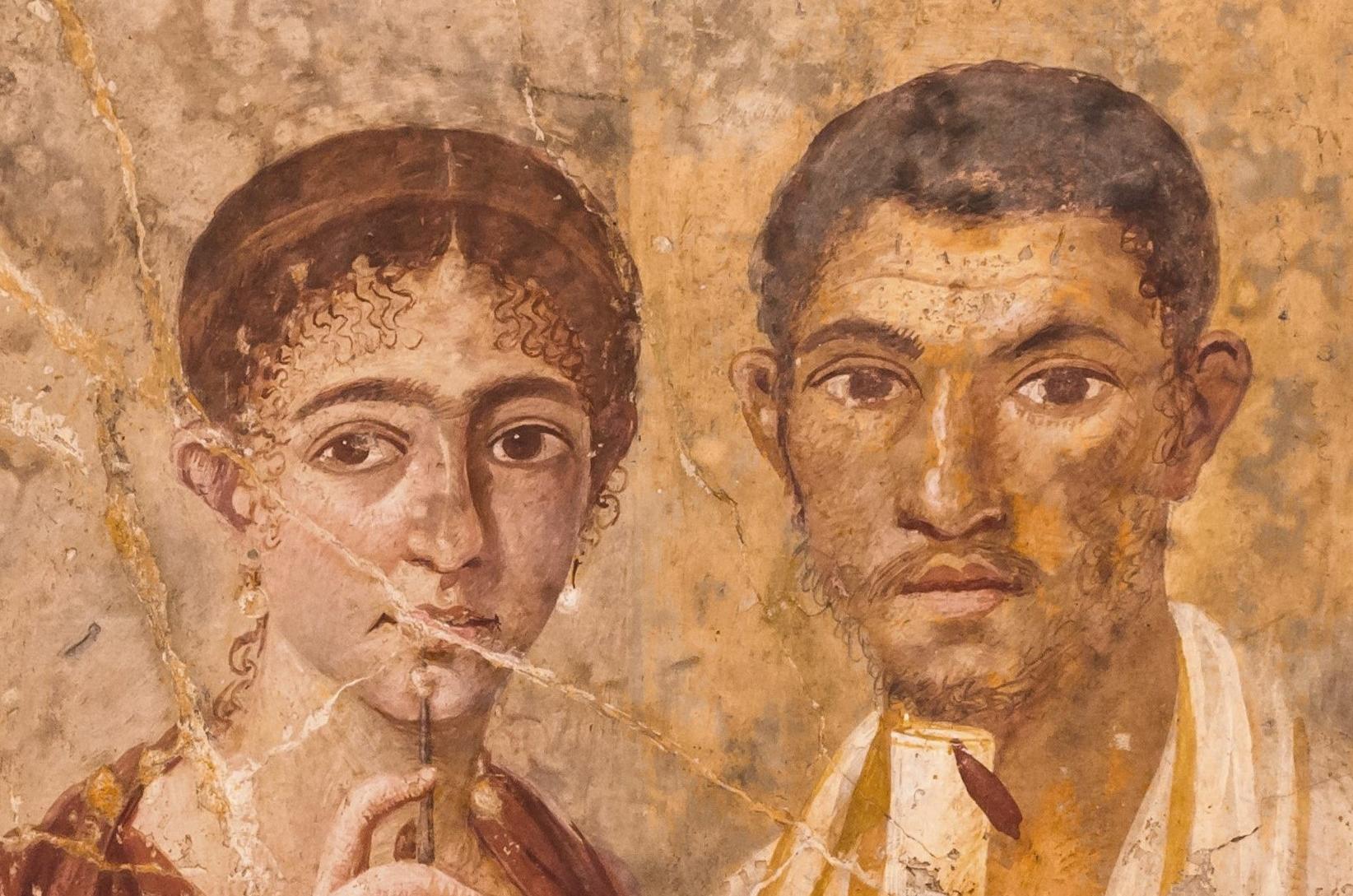 Roman fresco from Pompei depicting a man holding a scroll and a woman holding a stylus and wax tablet.